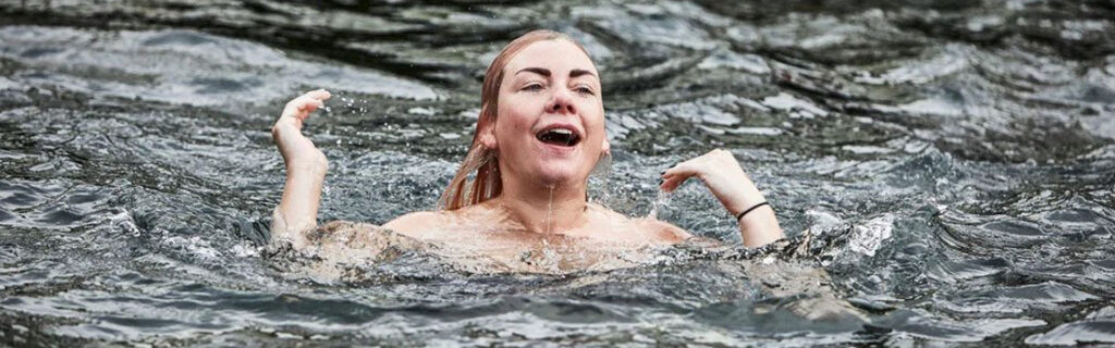 happy woman doing a water plunge
